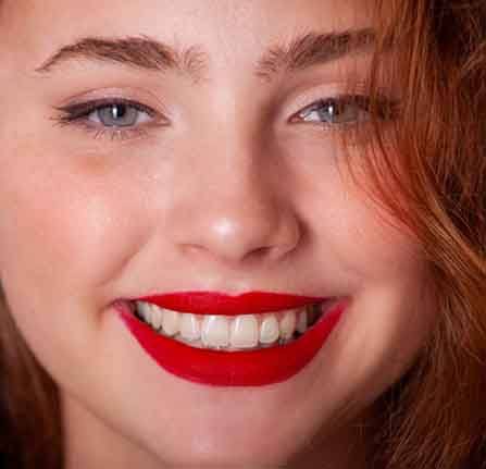 Close up of a woman with red lipstick smiling
