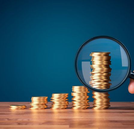 Coins examined with magnifying glass